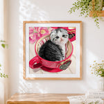 Finished scottish fold kitten in red teacup cross stitch artwork displayed