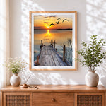 Finished serene wooden pier sunset cross stitch artwork displayed