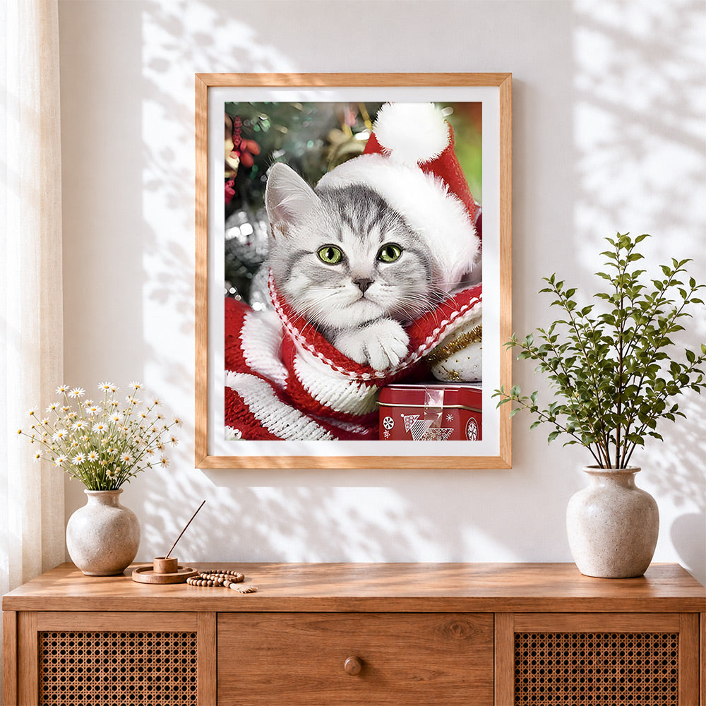 Finished silver tabby cat in a santa hat cross stitch artwork displayed