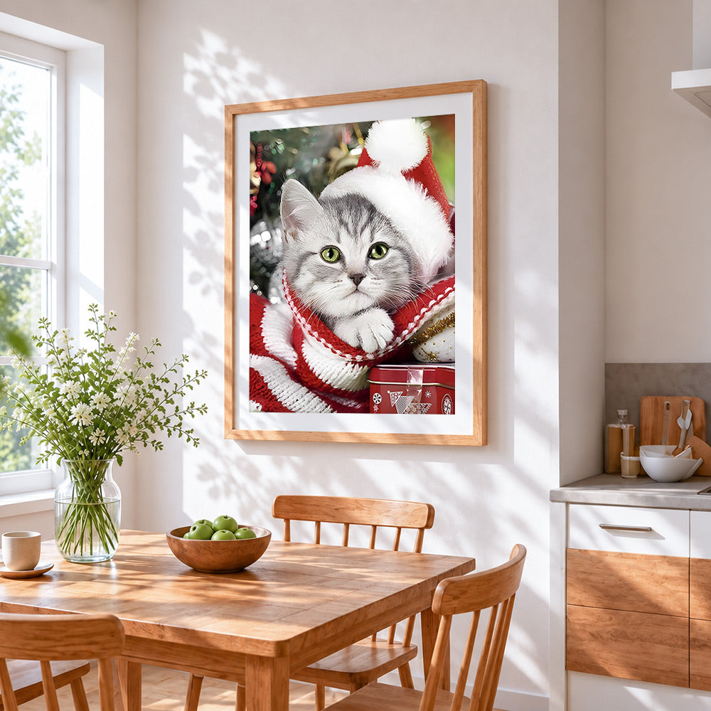 Silver tabby cat in a santa hat cross stitch artwork displayed on wall as home decor