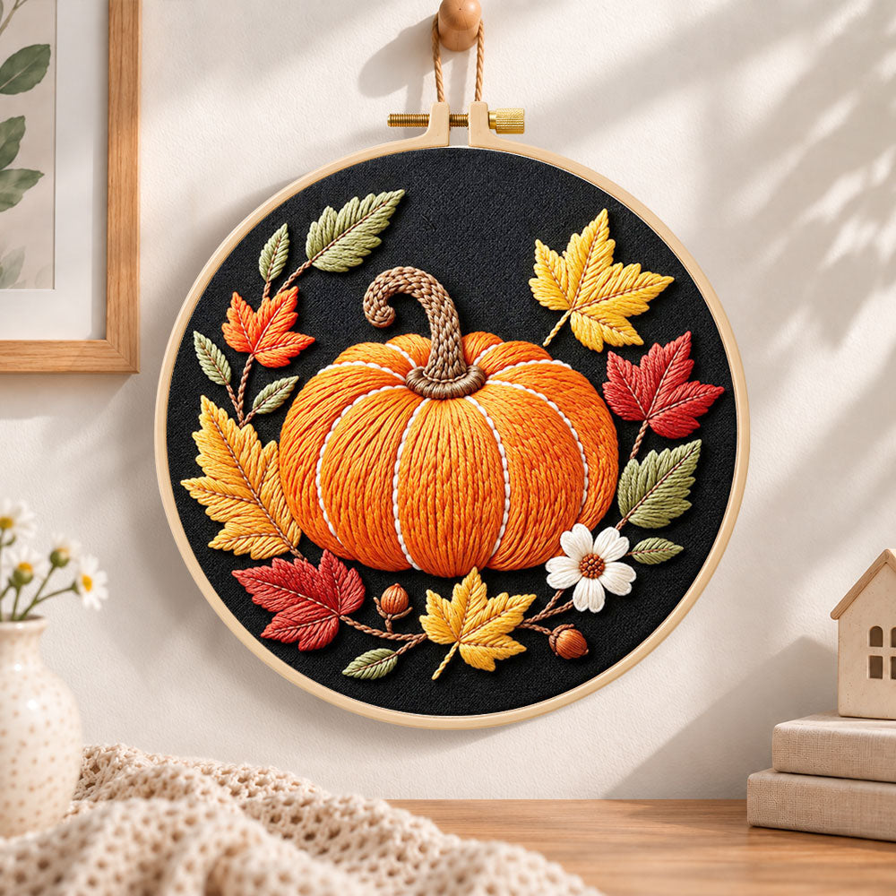 Single pumpkin on black fabric embroidery hoop wall art displayed as warm and cosy handmade home decor