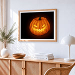 Sinister glowing jack o lantern cross stitch artwork displayed on wall as home decor