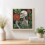 Finished skeleton holding blooms artwork displayed on a wall