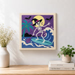 Finished skeleton witch surfing waves artwork displayed on a wall