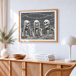 Skeletons behind barbed wire cross stitch artwork displayed on wall as home decor