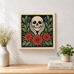 Finished skull cupping cheeks with autumn blooms artwork displayed on a wall