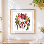 Finished skull with diamond eyes cross stitch artwork displayed