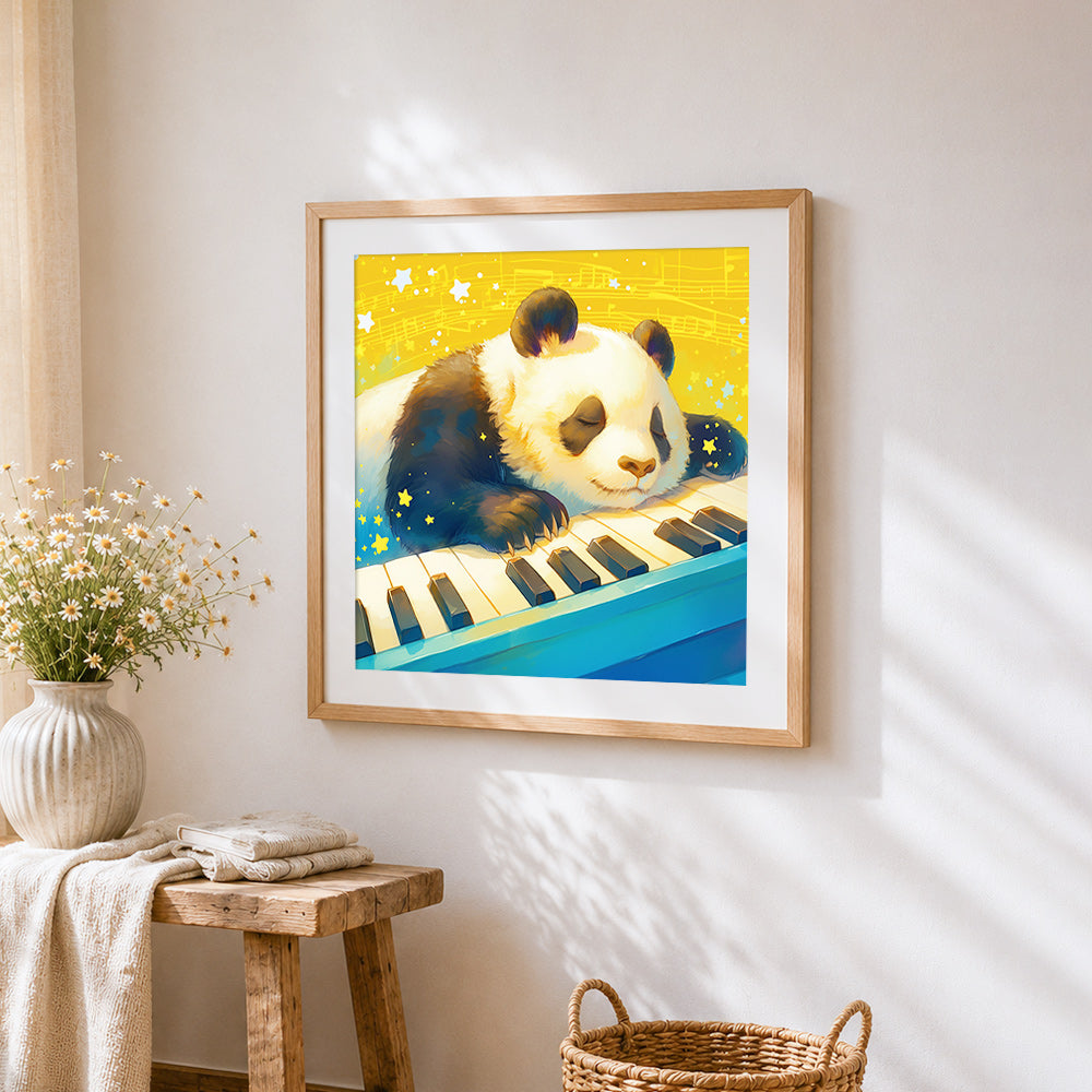 Sleepy panda on a piano keyboard cross stitch artwork displayed on wall as home decor
