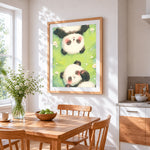 Sleepy pandas in the grass cross stitch artwork displayed on wall as home decor