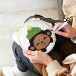 Creating handmade smiling little monkey punch needle artwork