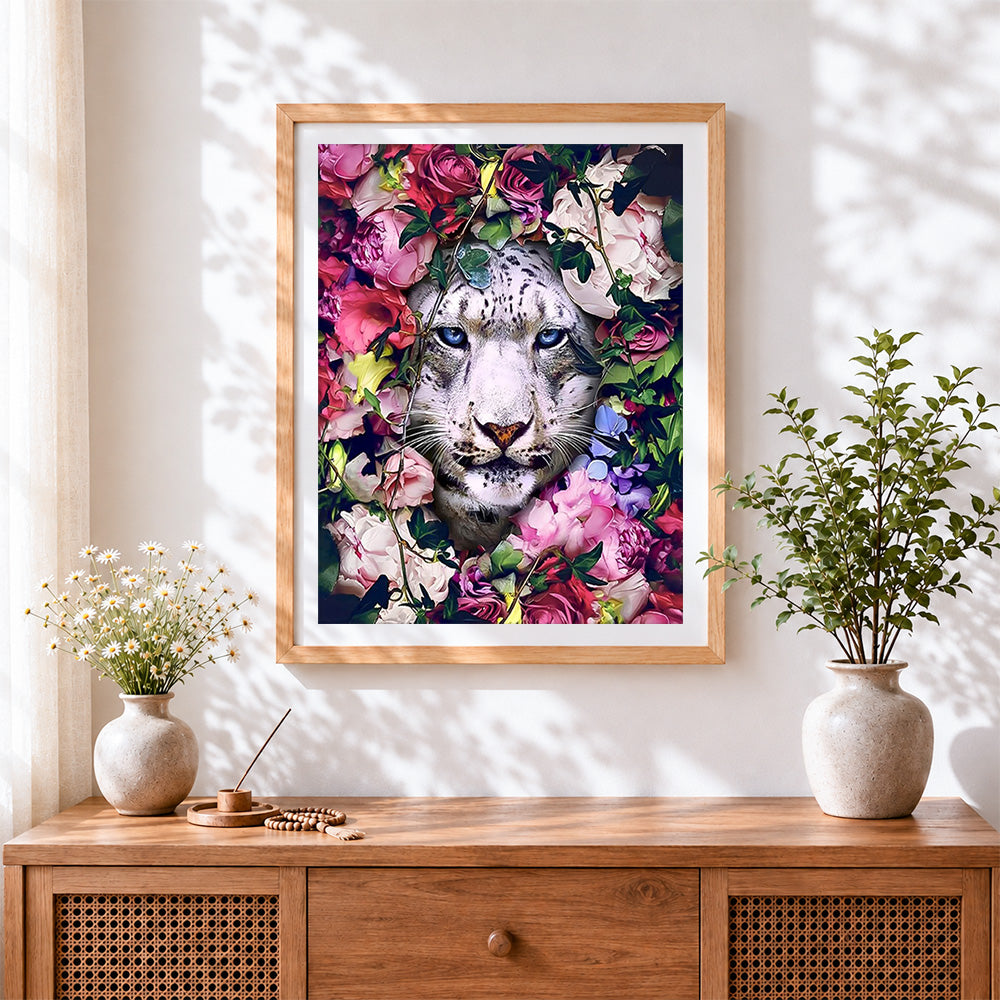 Finished snow leopard in flowers cross stitch artwork displayed