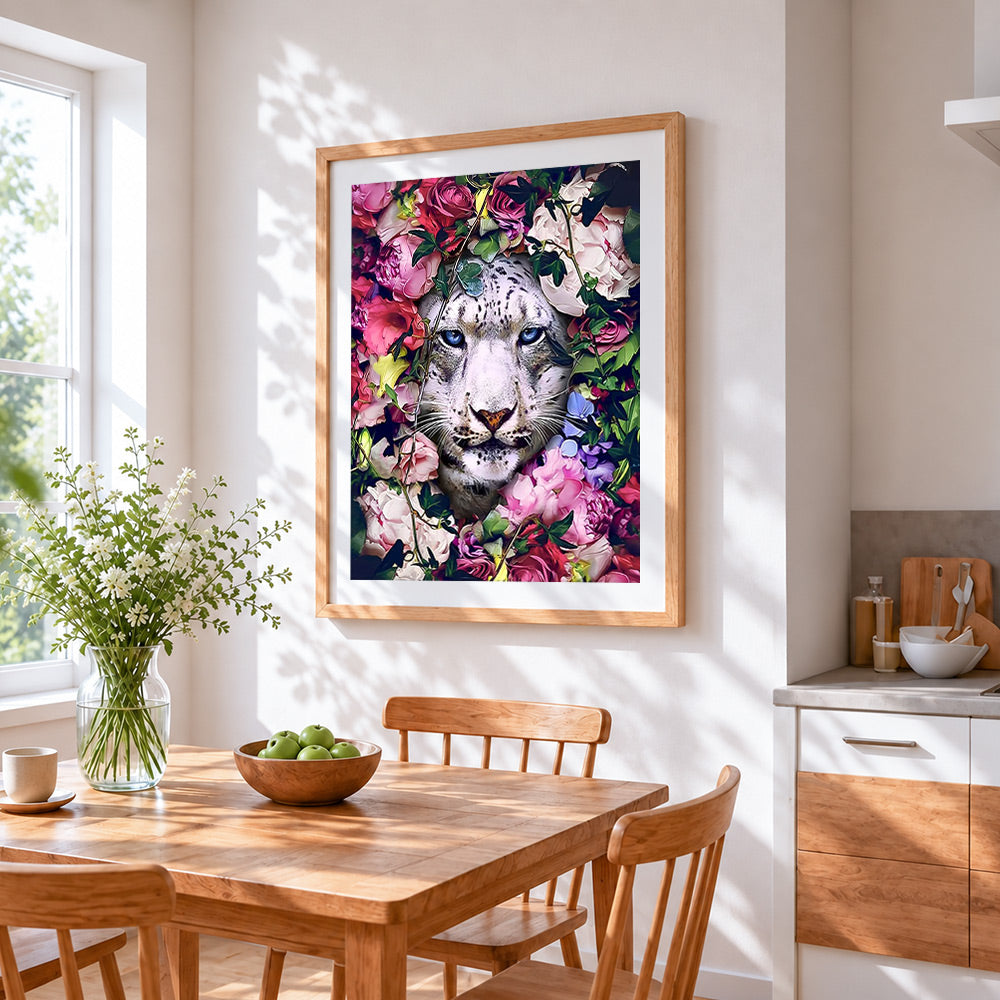 Snow leopard in flowers cross stitch artwork displayed on wall as home decor