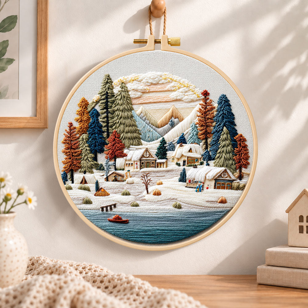 Snow mountain village embroidery hoop wall art displayed as warm and cosy handmade home decor