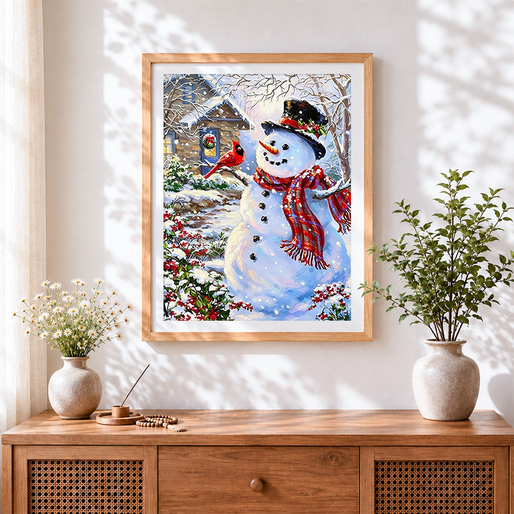 Finished snowman and cardinal in the snow cross stitch artwork displayed