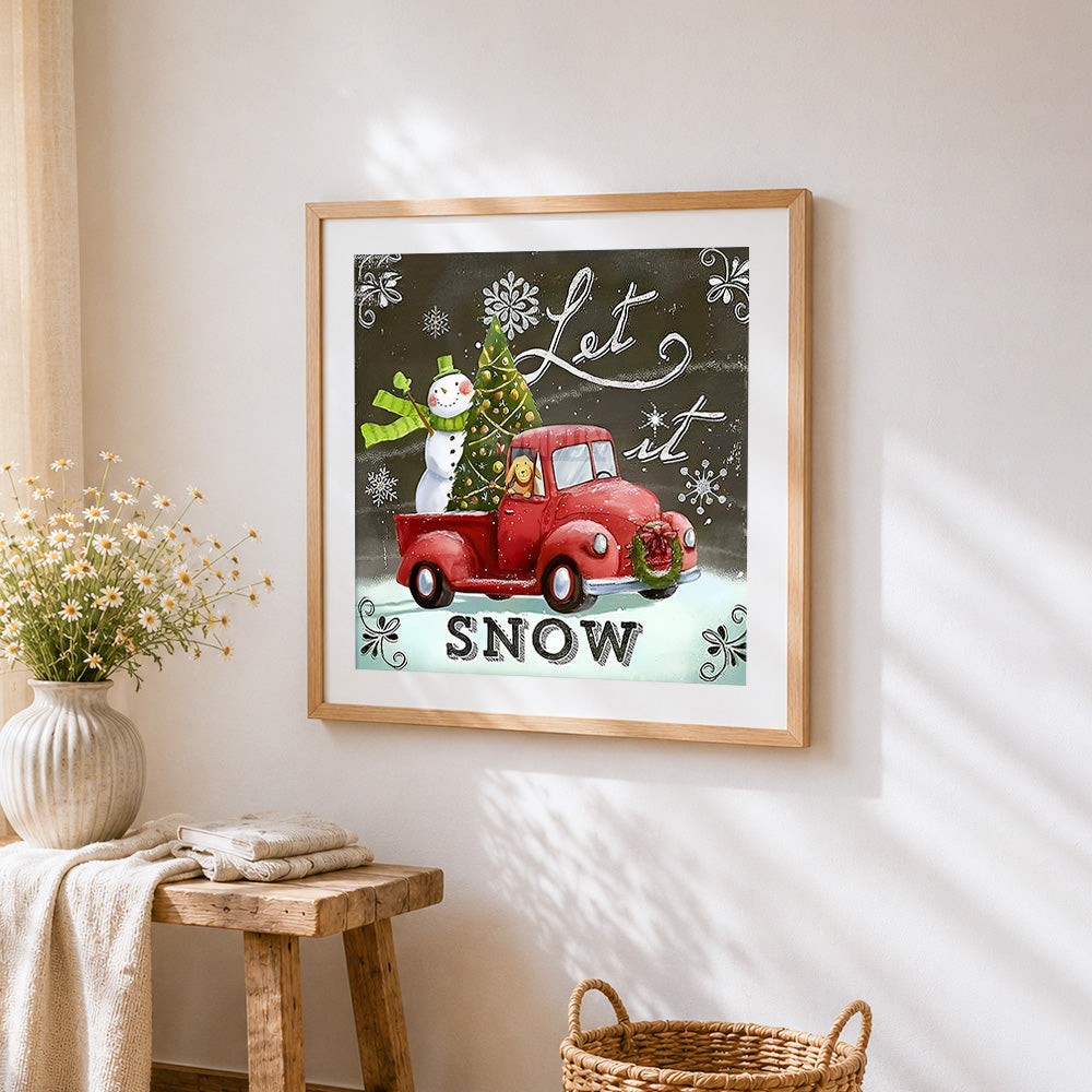 Snowman and red truck cross stitch artwork displayed on wall as home decor
