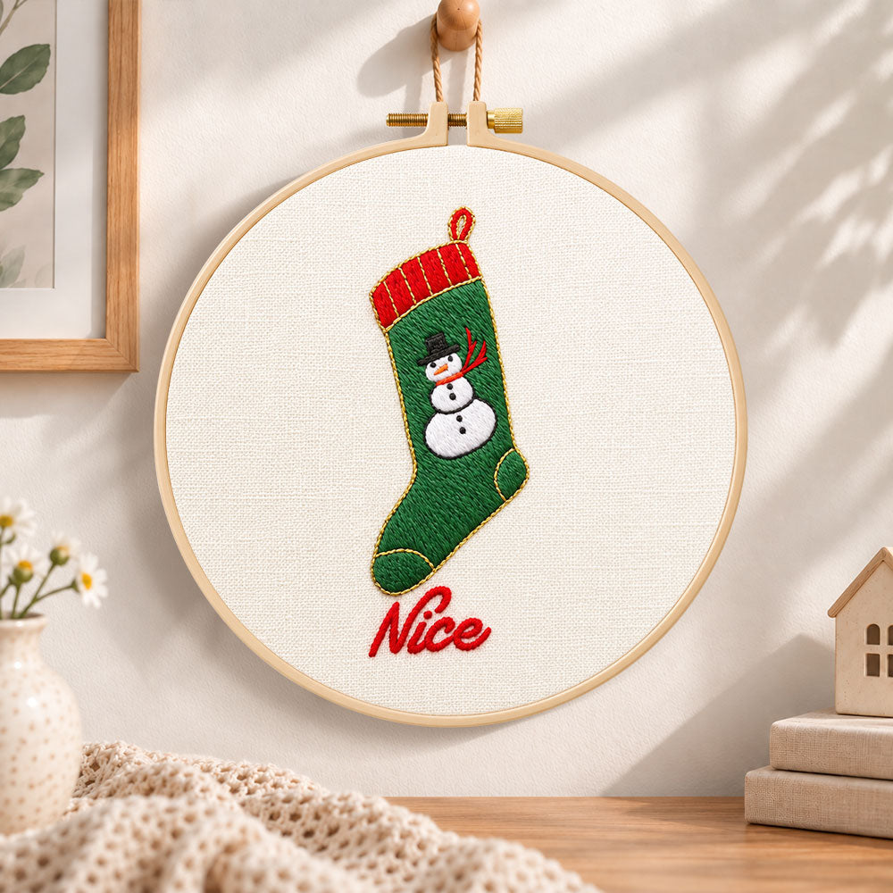 Snowman christmas stocking embroidery hoop wall art displayed as warm and cozy handmade home decor