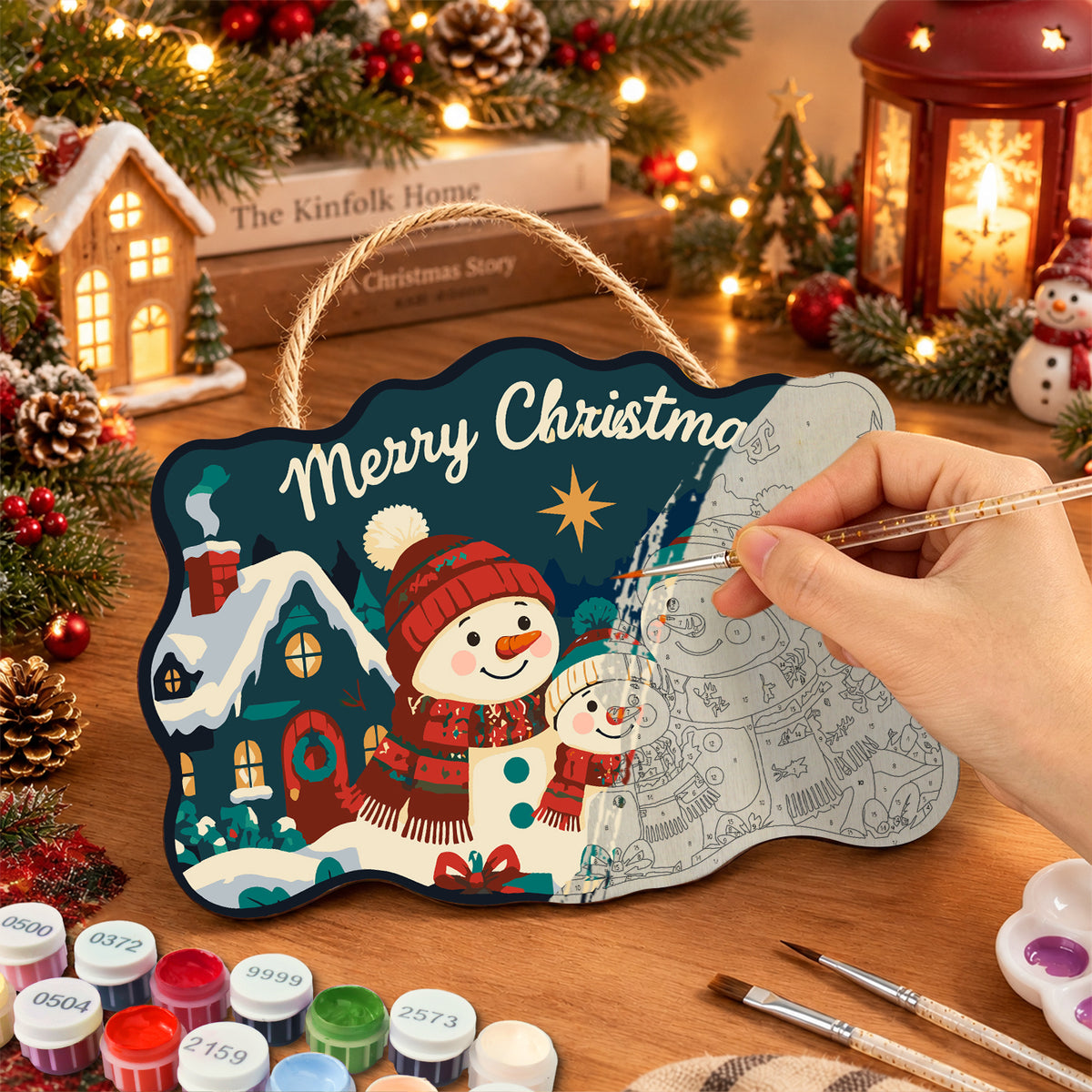 Snowman family with cosy cottage paint by numbers door hanger painting process