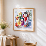 Snowman family with gifts and sleigh cross stitch artwork displayed on wall as home decor
