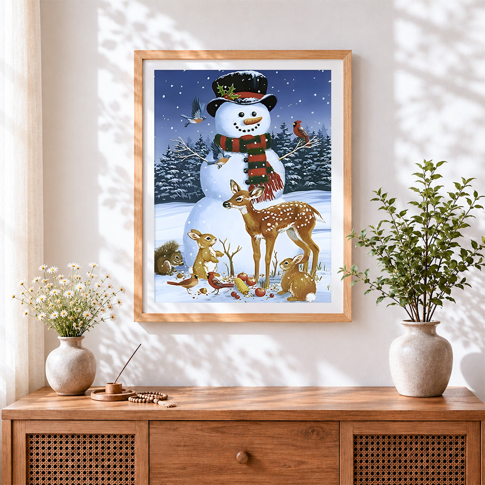 Finished snowman feeding deer, rabbits and birds cross stitch artwork displayed