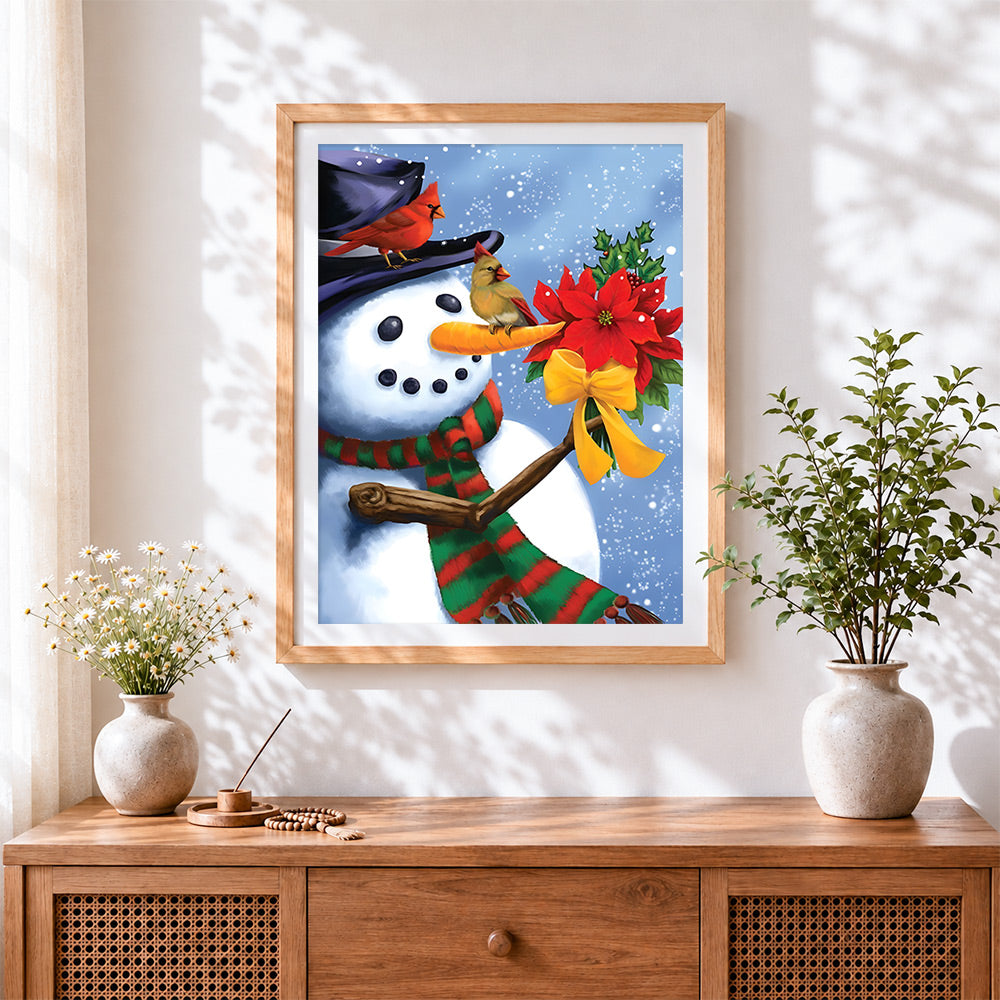 Finished snowman holding poinsettia cross stitch artwork displayed