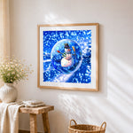 Snowman in a crystal ball cross stitch artwork displayed on wall as home decor