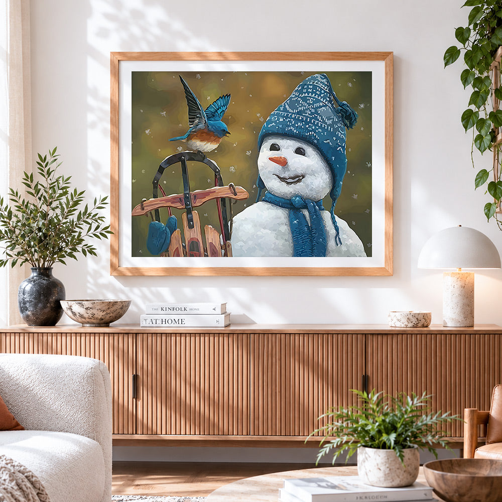 Finished snowman in blue knitted hat with little bird cross stitch artwork displayed