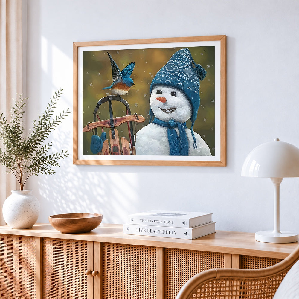 Snowman in blue knitted hat with little bird cross stitch artwork displayed on wall as home decor
