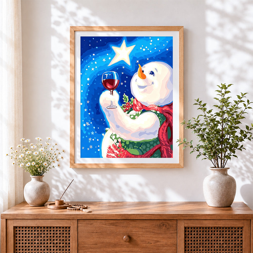 Finished snowman toasting with a glass of red wine cross stitch artwork displayed