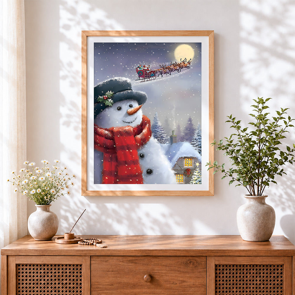 Finished snowman watching santa's sleigh cross stitch artwork displayed