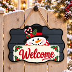 Snowman welcome paint by numbers door hanger on a garden gate