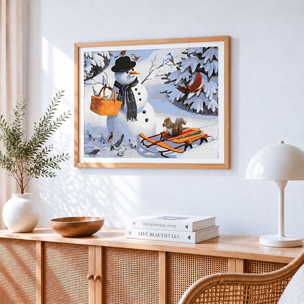 Snowman with basket and garden birds cross stitch artwork displayed on wall as home decor
