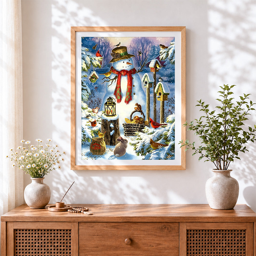 Finished snowman with birdhouses and woodland creatures cross stitch artwork displayed