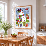 Snowman with christmas stockings and presents cross stitch artwork displayed on wall as home decor