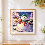 Finished snowman with lantern and bluebirds cross stitch artwork displayed