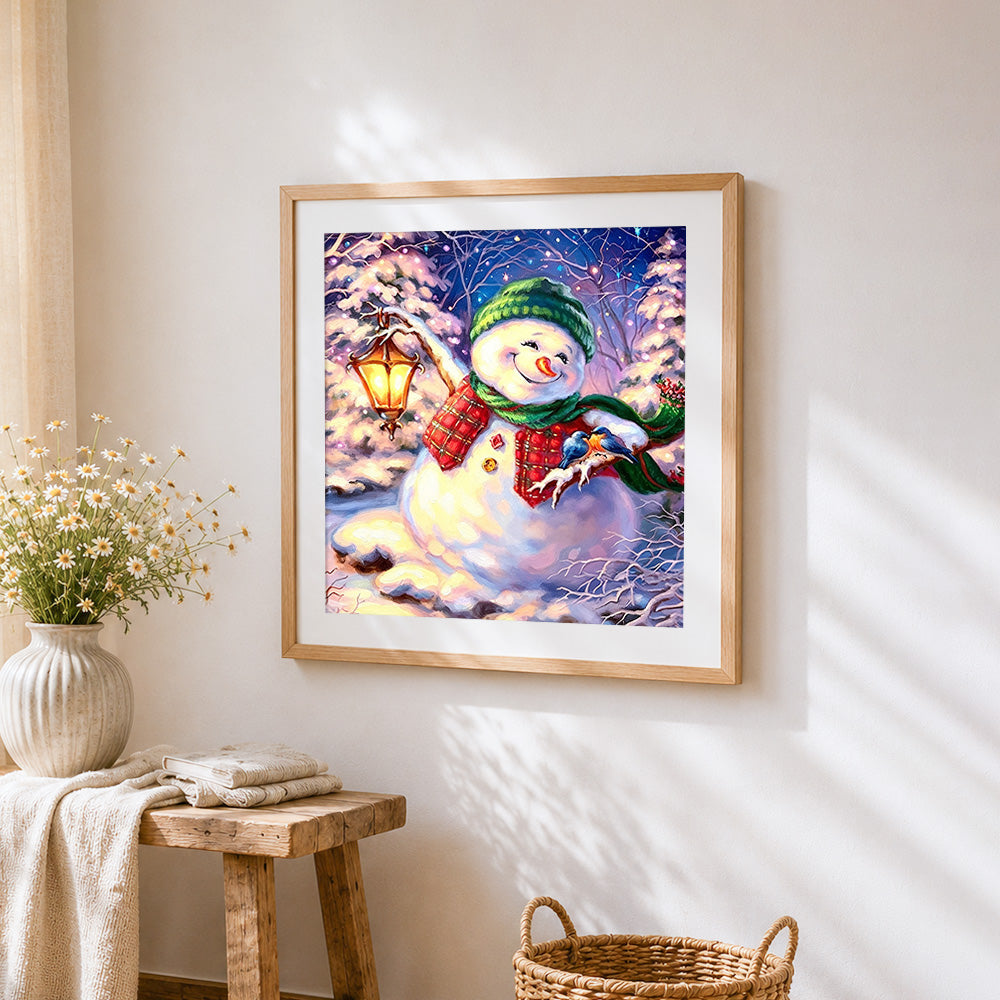 snowman with lantern and bluebirds cross stitch artwork displayed on wall as home decor
