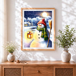 Finished snowman with lantern and broom cross stitch artwork displayed