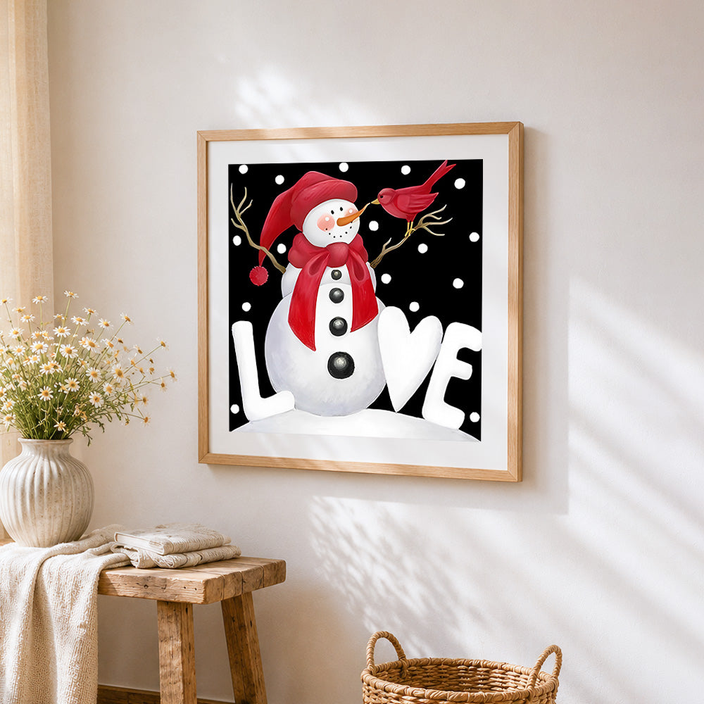 Snowman with red bird cross stitch artwork displayed on wall as home decor