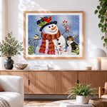 Finished snowman with robin and cat cross stitch artwork displayed