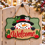 Snowman with top hat paint by numbers door hanger on a garden gate
