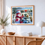 Snowman with winter birds cross stitch artwork displayed on wall as home decor