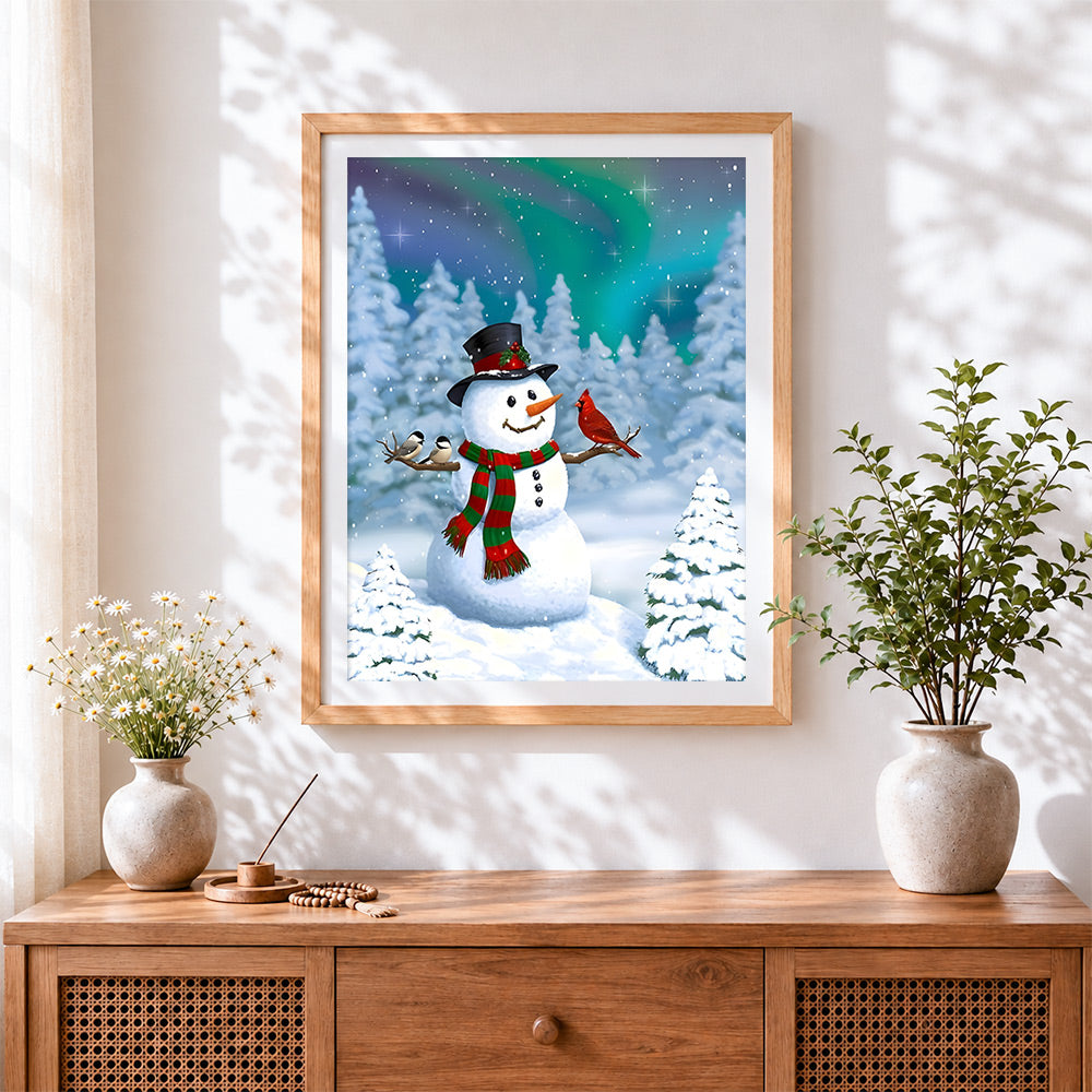 Finished snowman with winter birds under aurora night sky cross stitch artwork displayed