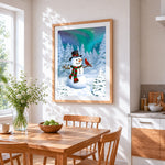 Snowman with winter birds under aurora night sky cross stitch artwork displayed on wall as home decor