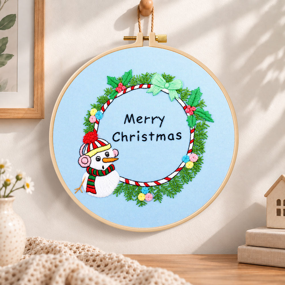 Snowman wreath quote embroidery hoop wall art displayed as warm and cosy handmade home decor