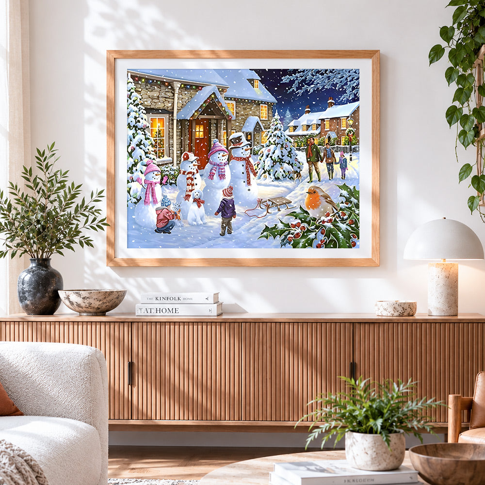 Finished snowmen and families in a festive village cross stitch artwork displayed