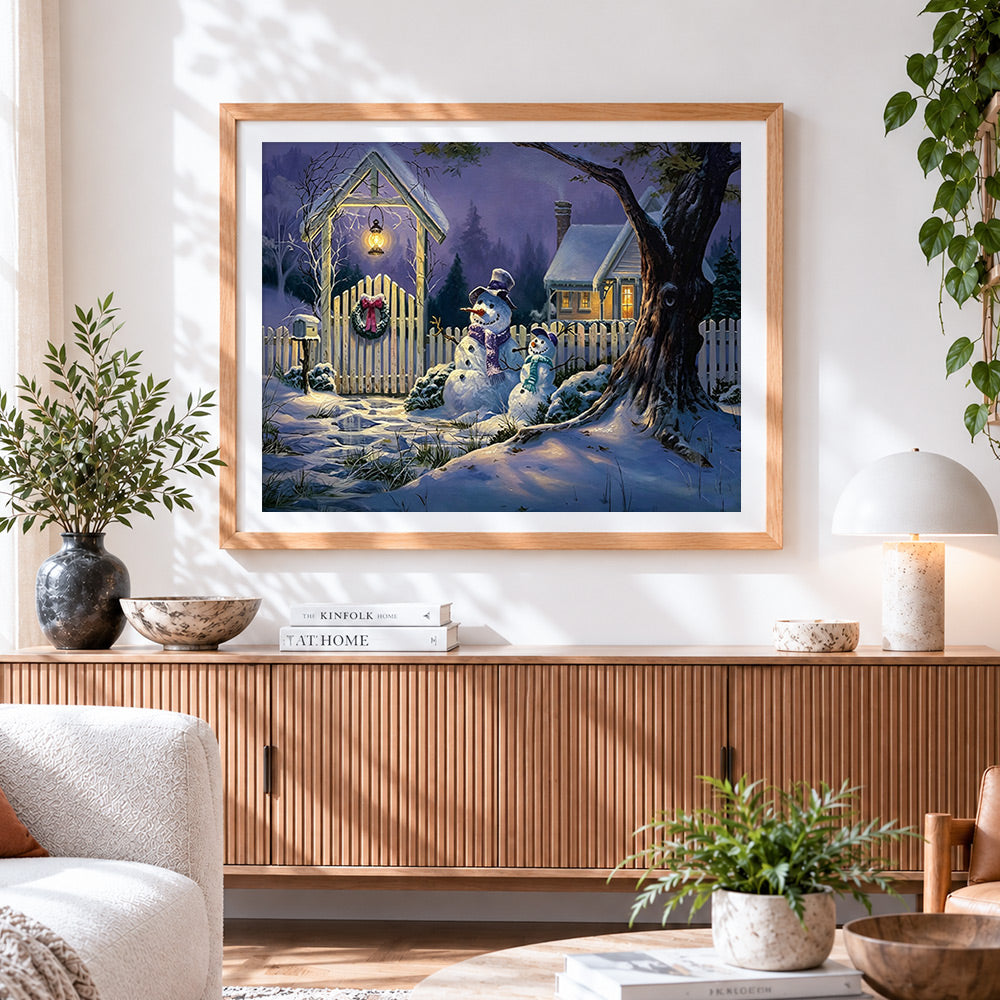 Finished snowmen by a fence at night cross stitch artwork displayed