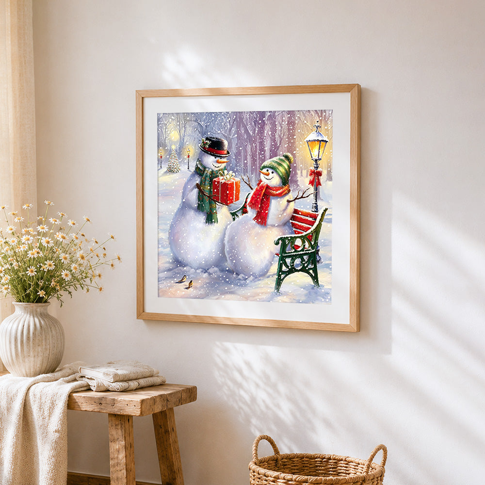 Snowmen couple with gift on a bench cross stitch artwork displayed on wall as home decor