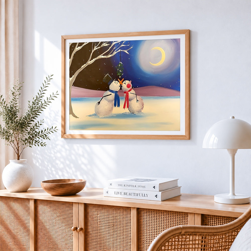 Snowmen kissing under the mistletoe cross stitch artwork displayed on wall as home decor