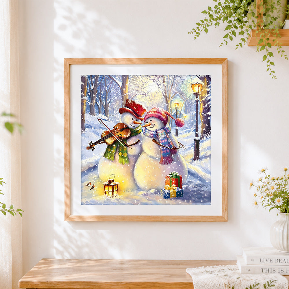 Finished snowmen playing violin in winter cross stitch artwork displayed