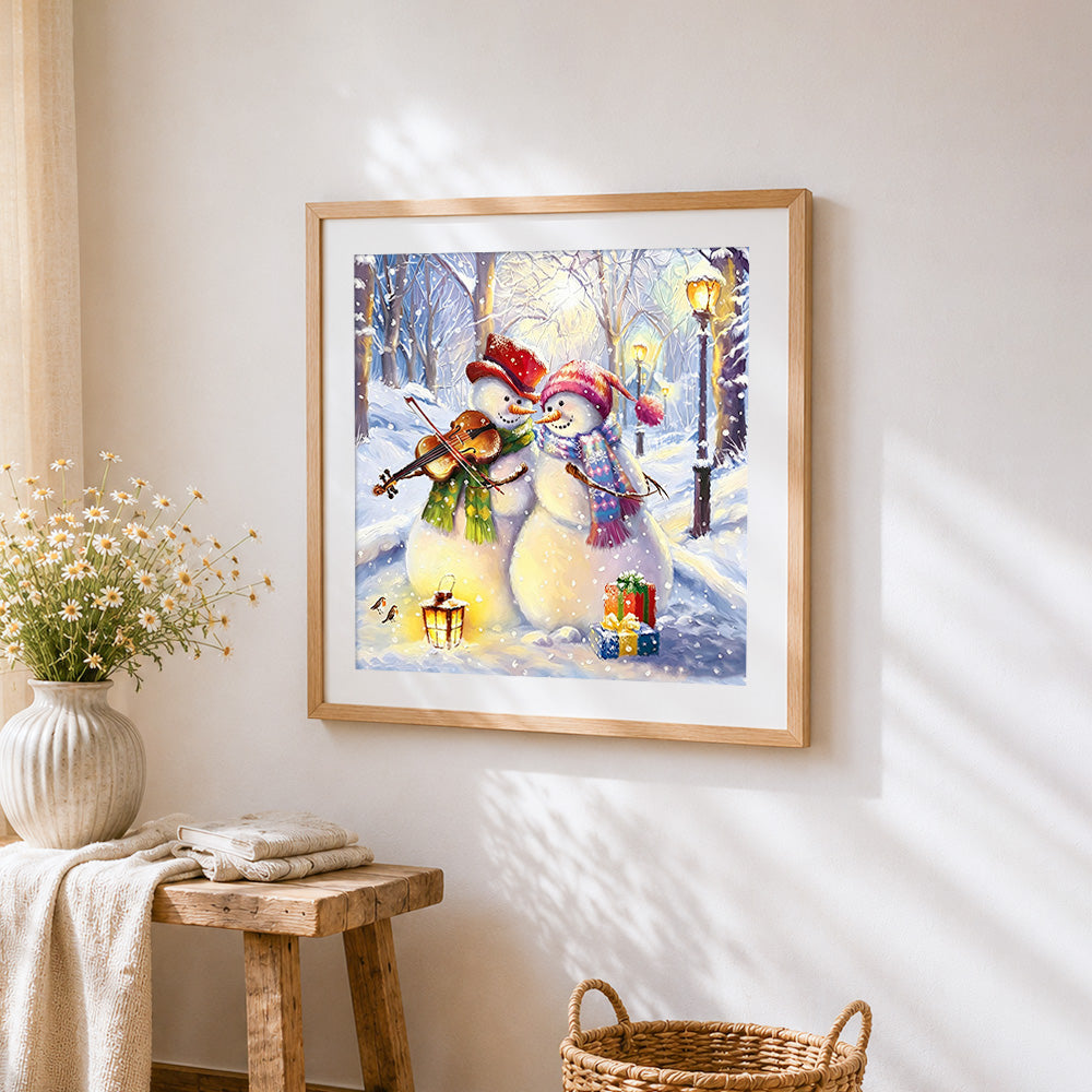 Snowmen playing violin in winter cross stitch artwork displayed on wall as home decor