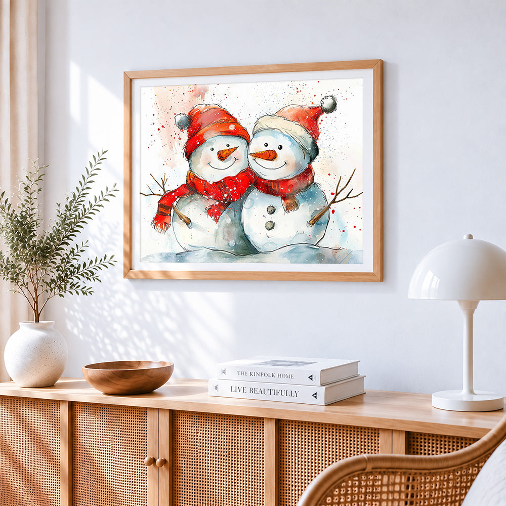 Snowmen with red scarves cross stitch artwork displayed on wall as home decor